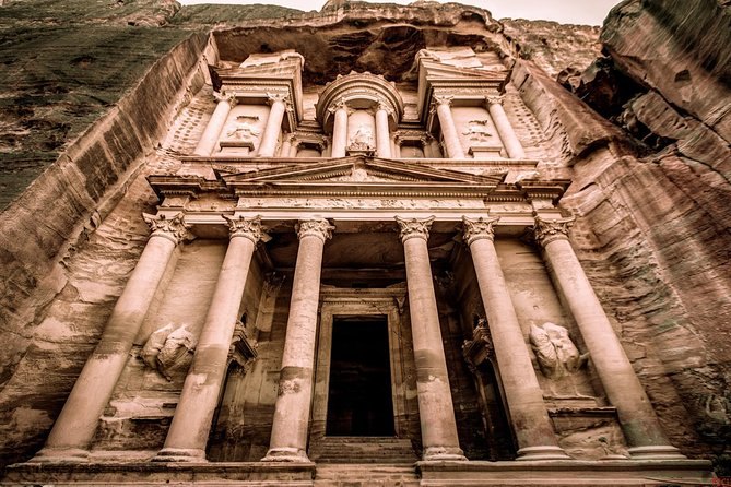 A rock-cut tomb front at Petra, its columns and cornice carved from the living cliff