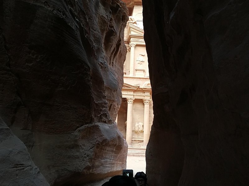 The Siq at Petra narrowing to a slot of daylight between its walls