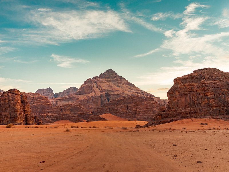 The wide floor of Wadi Rum with its flat-topped peaks behind
