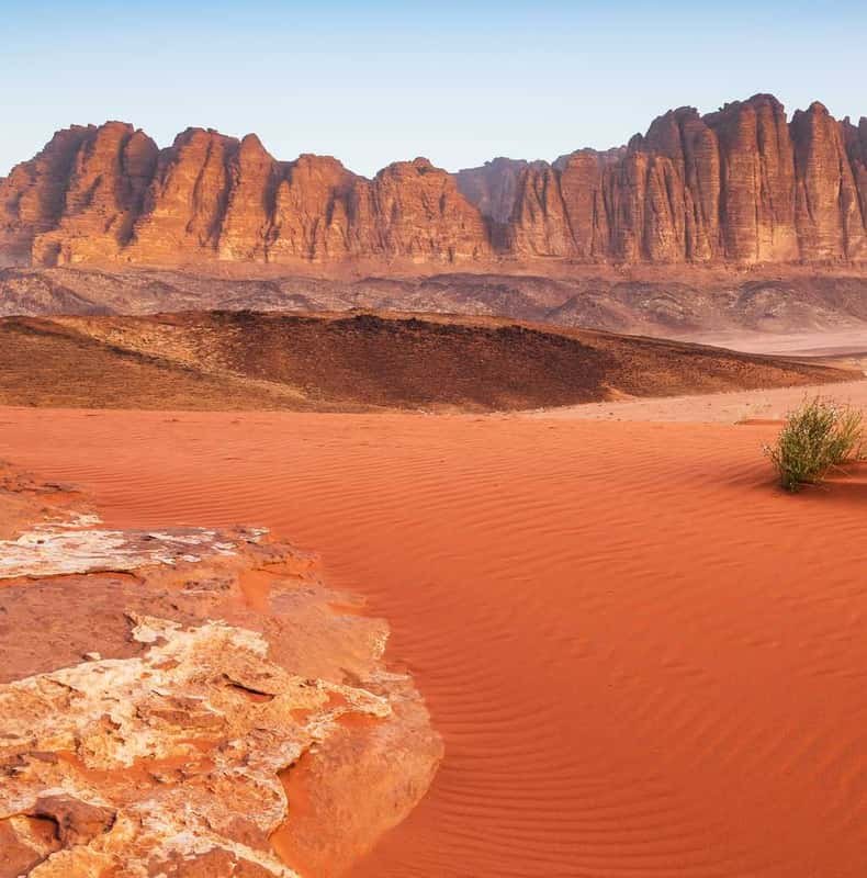 Red dunes running up against the cliffs of Wadi Rum